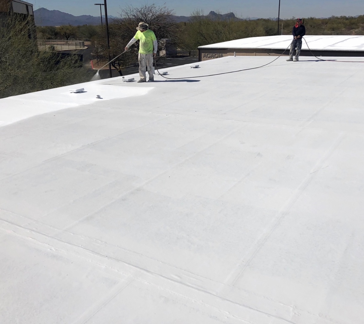 W&D Roofing church roof primed with top coat application in progress