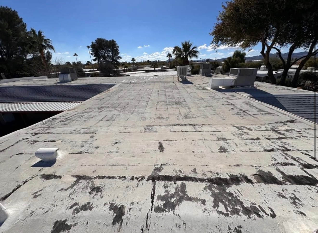 Before photo of aged flat roof before W&D Roofing roof coating restoration
