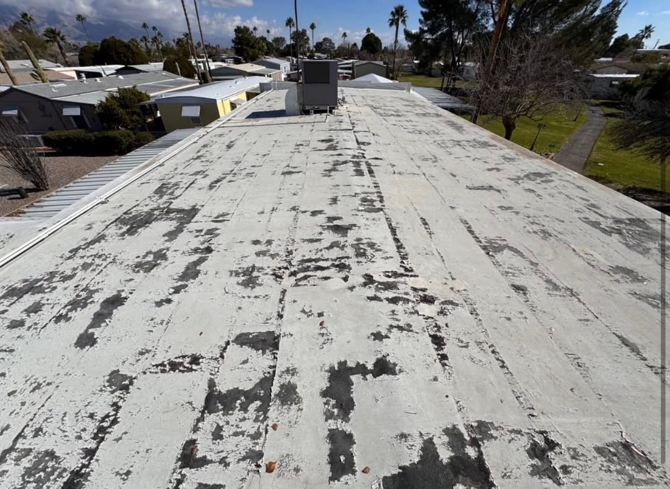 Second before photo of aging flat roof before roof coating restoration by W&D Roofing