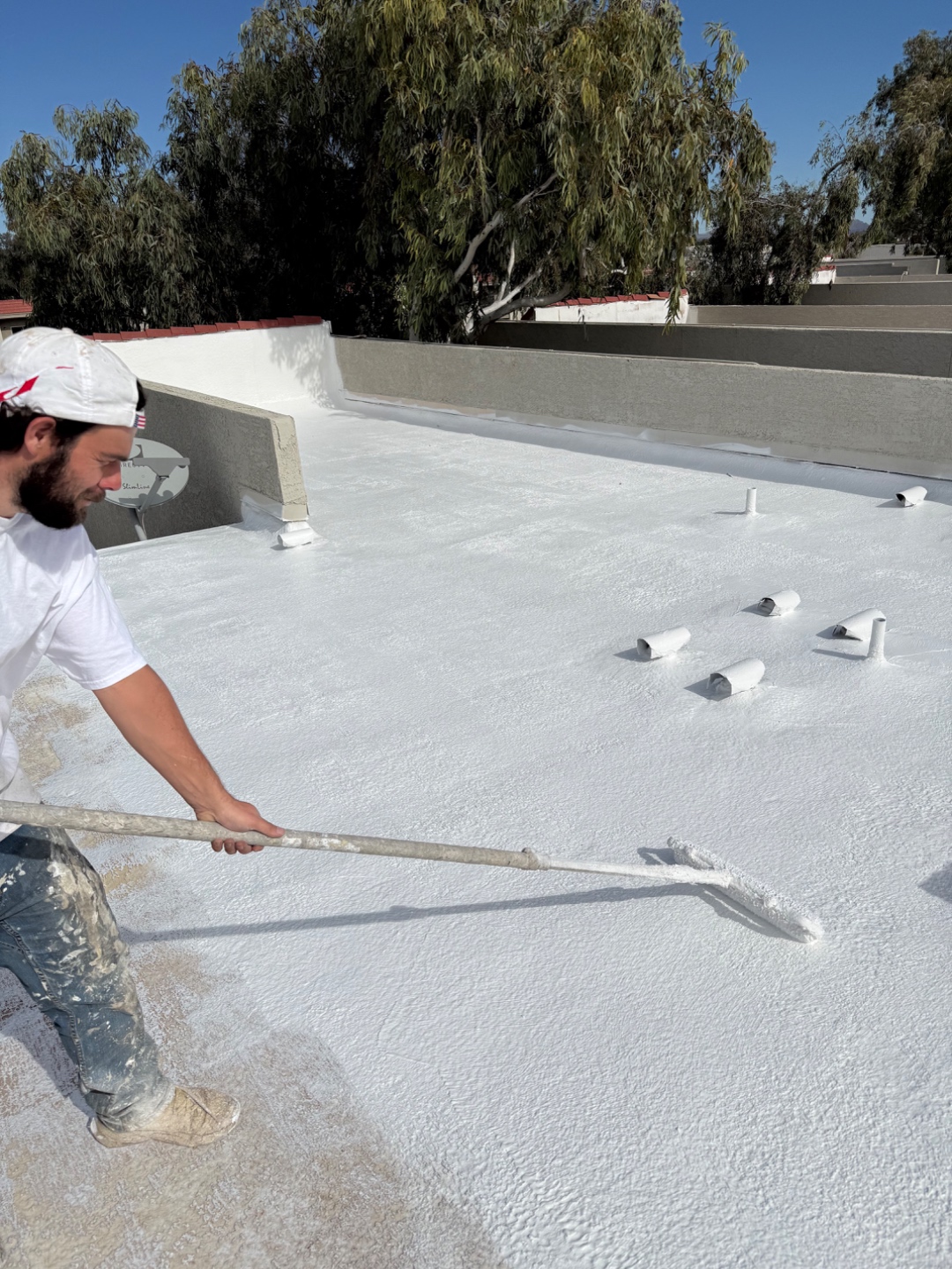 W&D Roofing professional roof coating application in progress