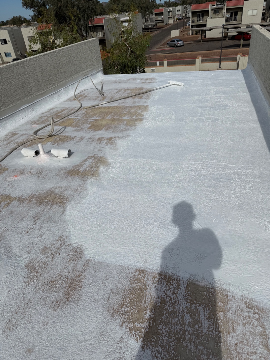 W&D Roofing first coat application on a flat roof coating project
