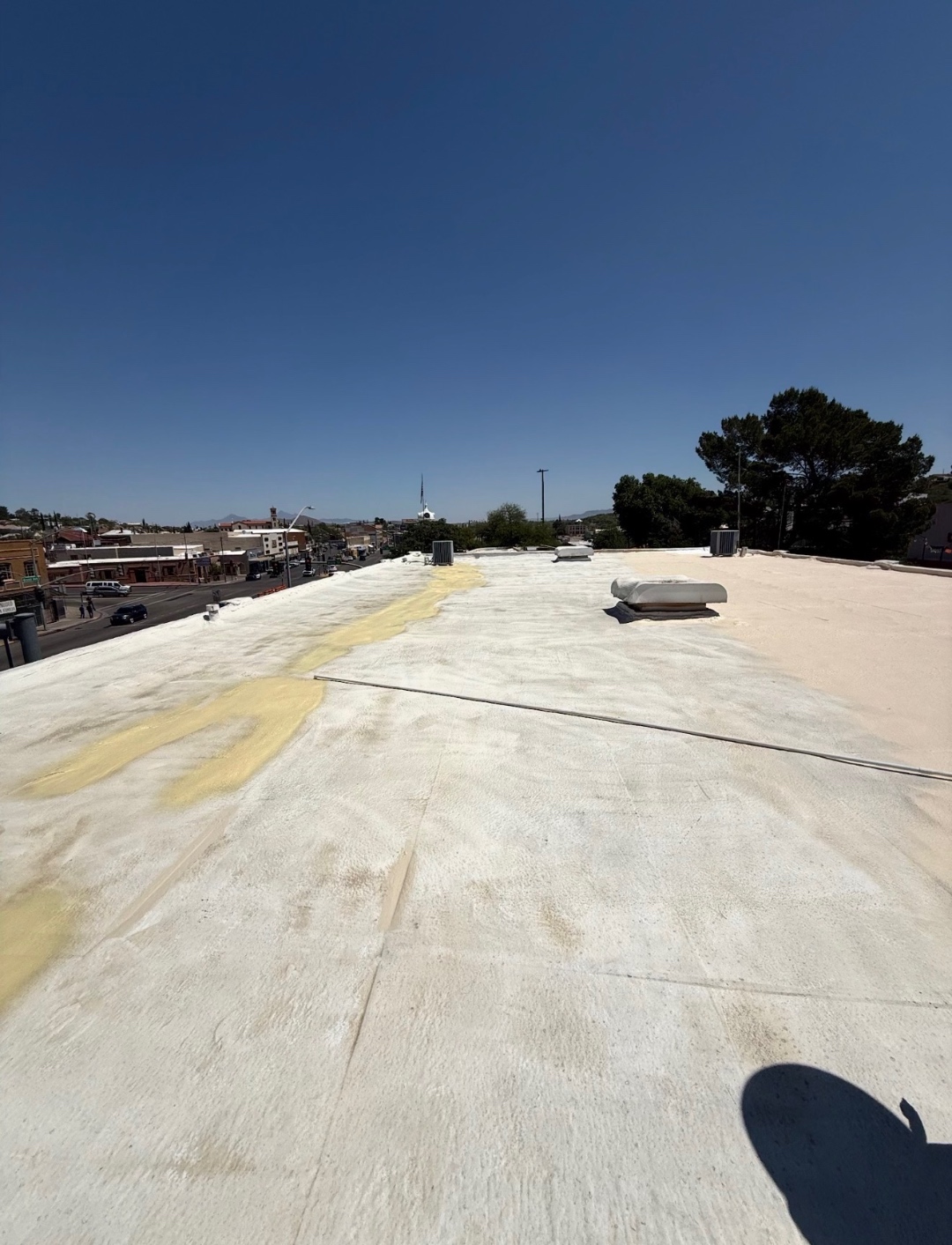W&D Roofing roof repair and coating preparation on a flat roof