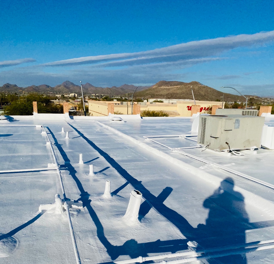 Completed polyurethane foam commercial roof system with protective reflective coating by W&D Roofing