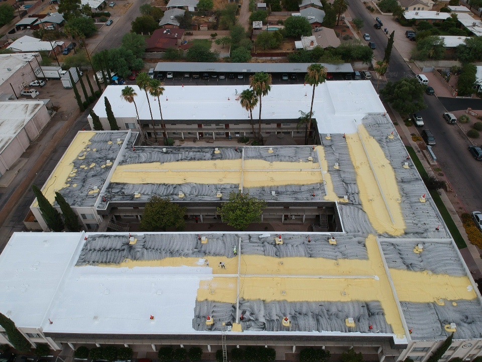 Commercial roof repair and coating progress photo by W&D Roofing showing roof sections being restored