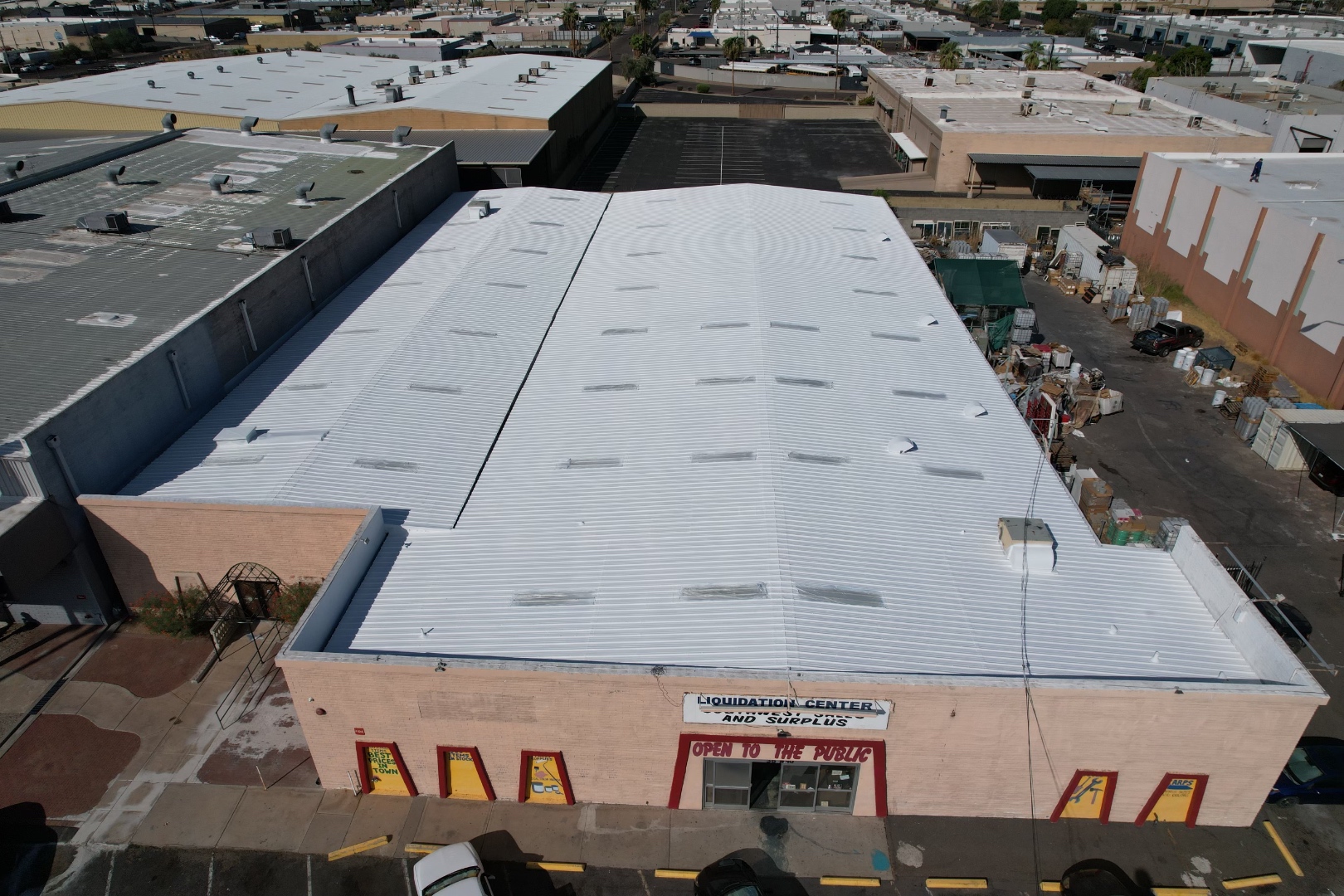 Completed W&D commercial roof coating project with reflective white roof system
