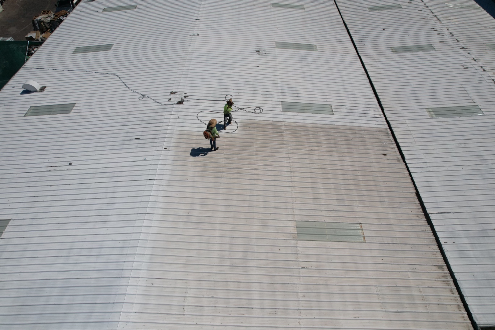 W&D Roofing commercial roof coating crew viewed from a drone