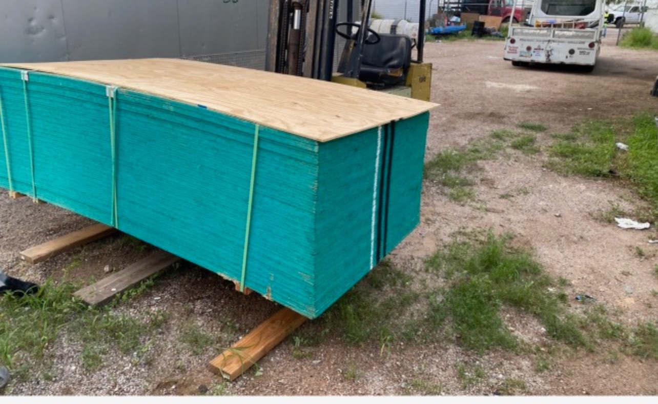 Wood decking materials staged for a W&D Roofing roof replacement project
