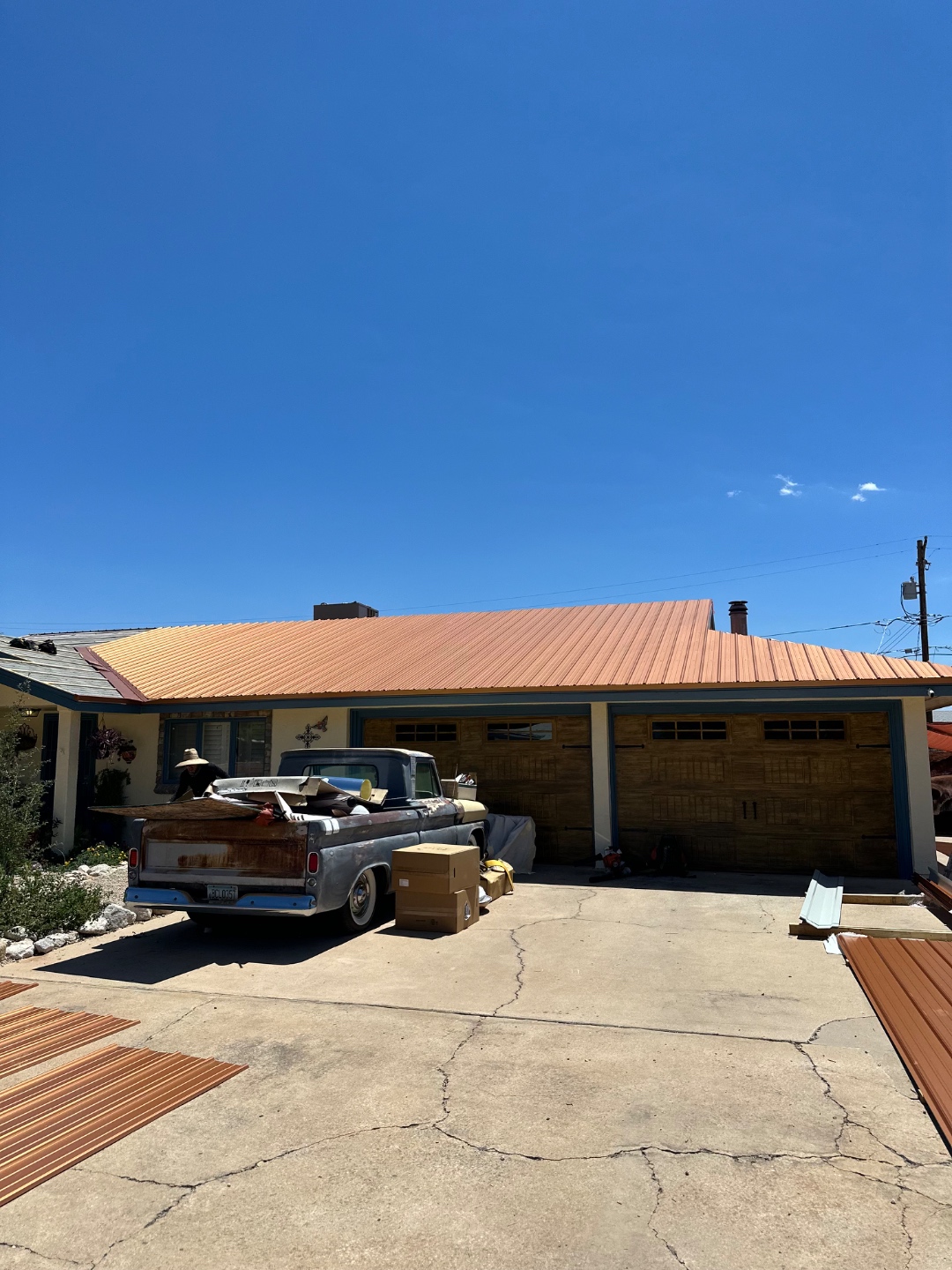 Arizona metal roofing project showing completed roof planes and driveway view