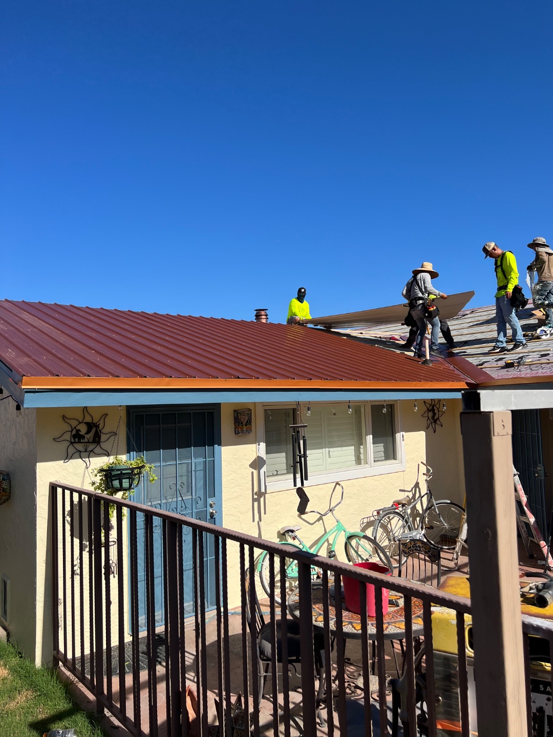 W&D Roofing crew installing metal roofing panels on an Arizona property