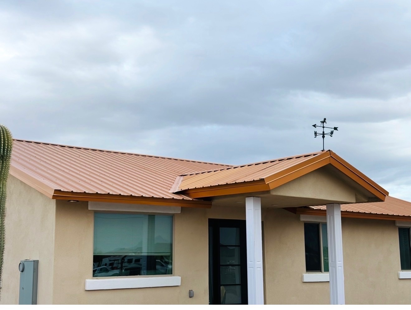 Completed metal roofing system with copper-tone panels on an Arizona home