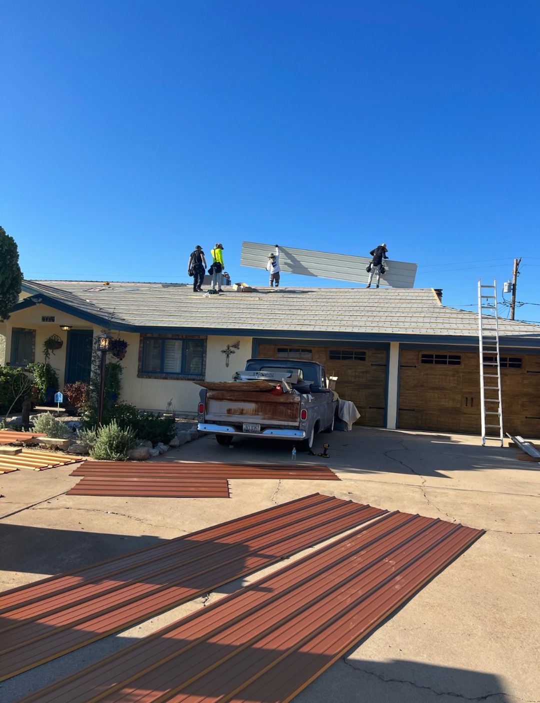 W&D Roofing crew at work installing a metal roofing system on an Arizona project