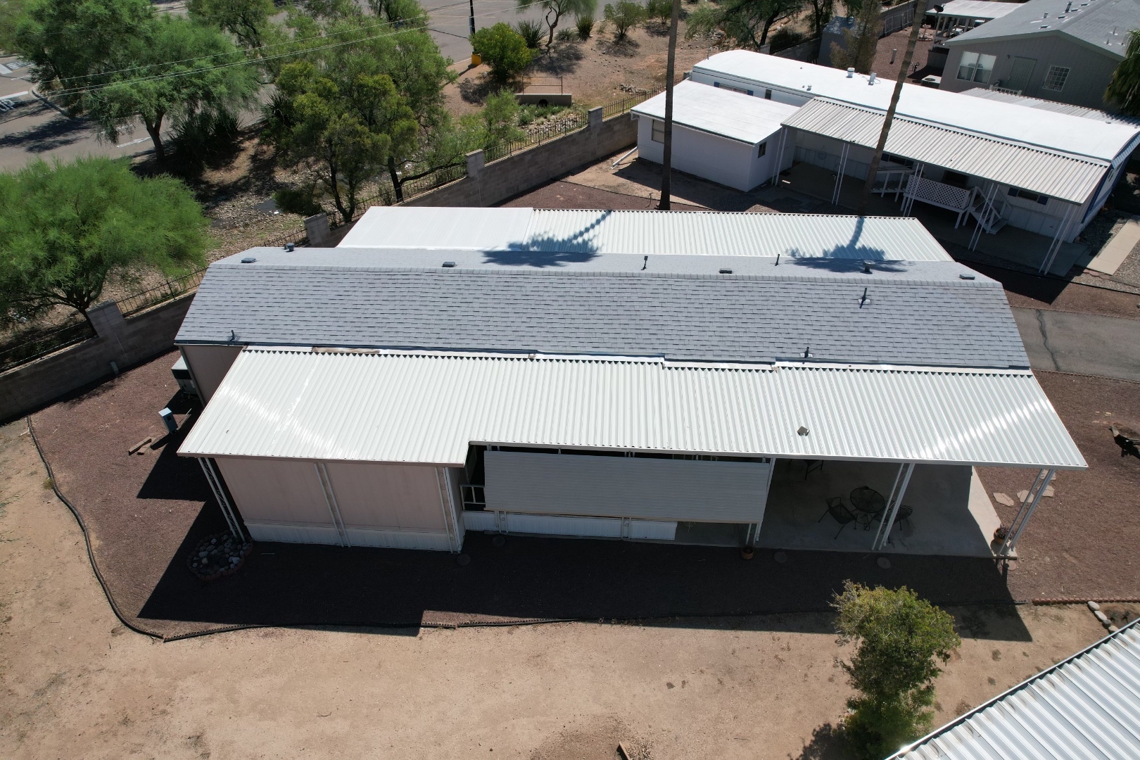 Completed W&D Roofing residential project with shingle roof and metal awning replacement