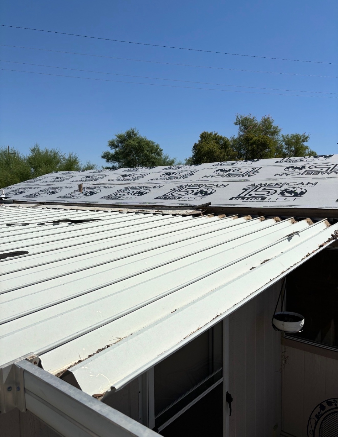 Metal awning tear-off during W&D Roofing replacement project