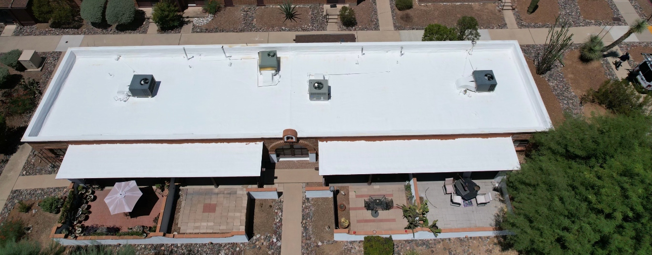 Completed W&D flat foam roof with white reflective coating viewed from above