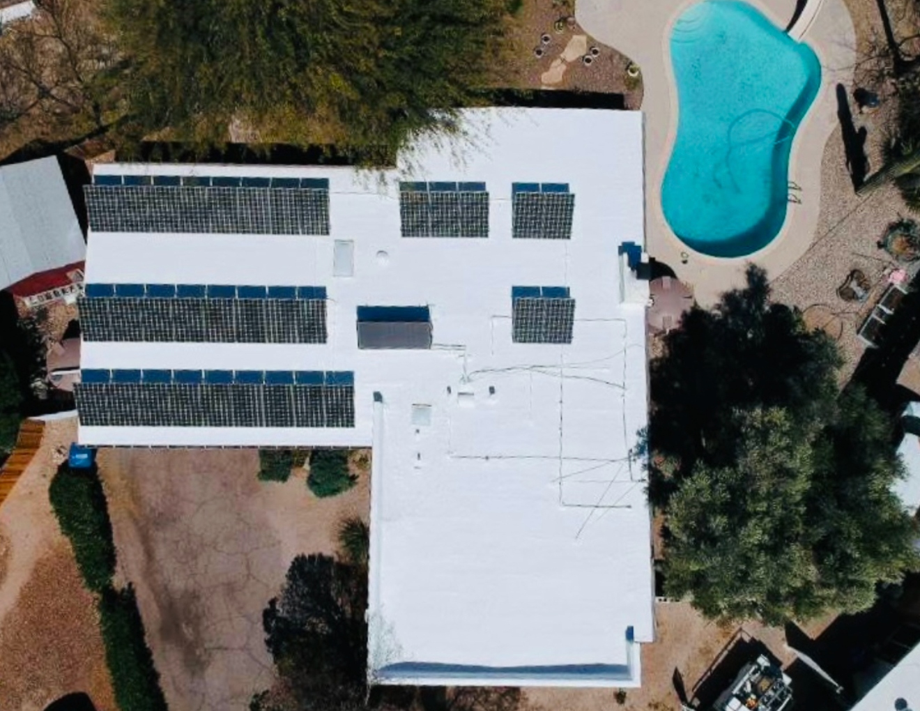 Completed W&D commercial foam roof with reflective coating and solar panels