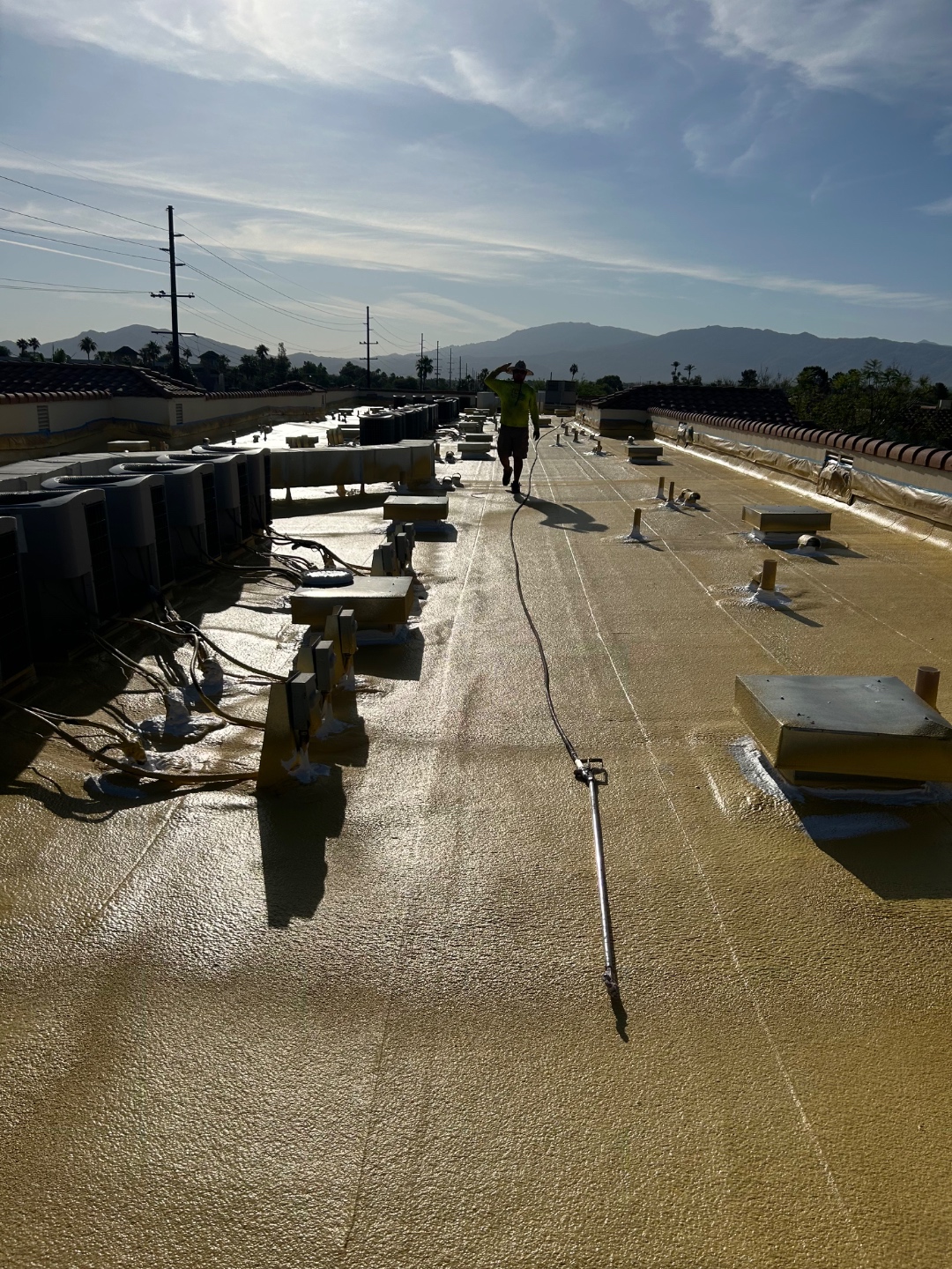 W&D Roofing foam installation pass on a commercial flat roof