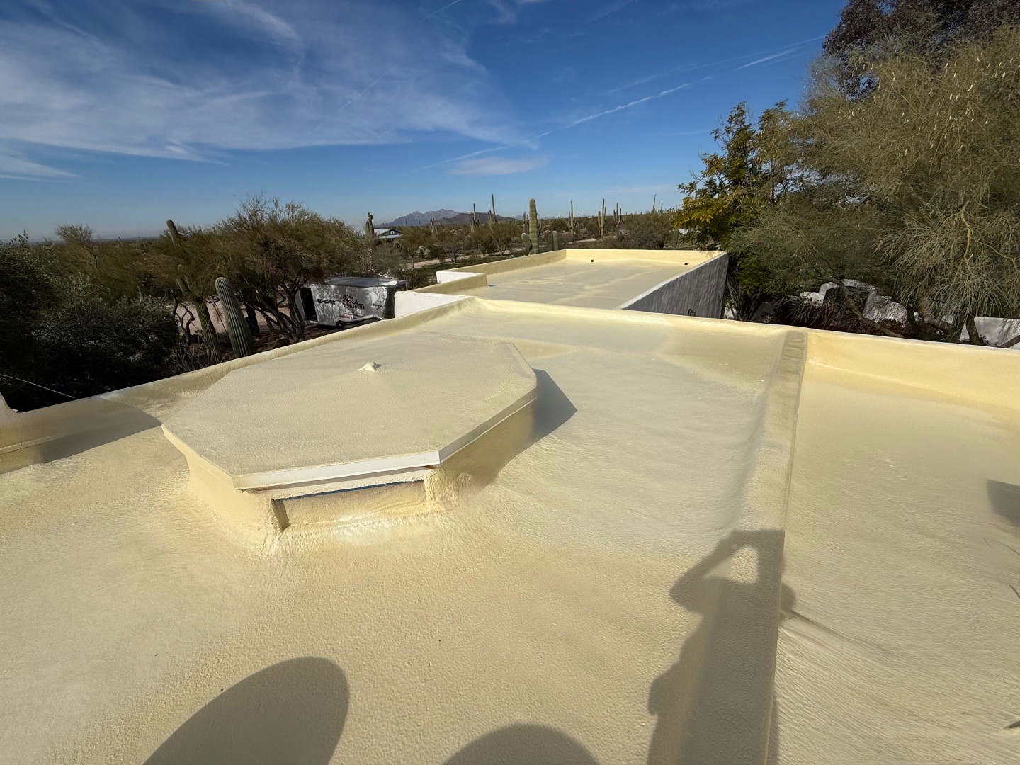 Freshly sprayed W&D foam roofing system on a flat roof before reflective coating