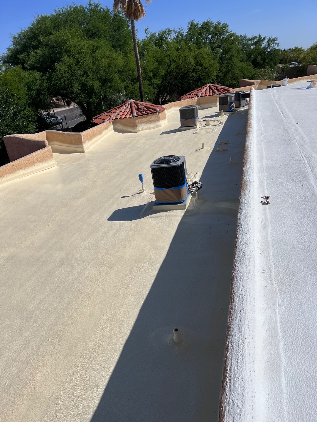 Detailed W&D spray foam roof installation on an Arizona flat roof