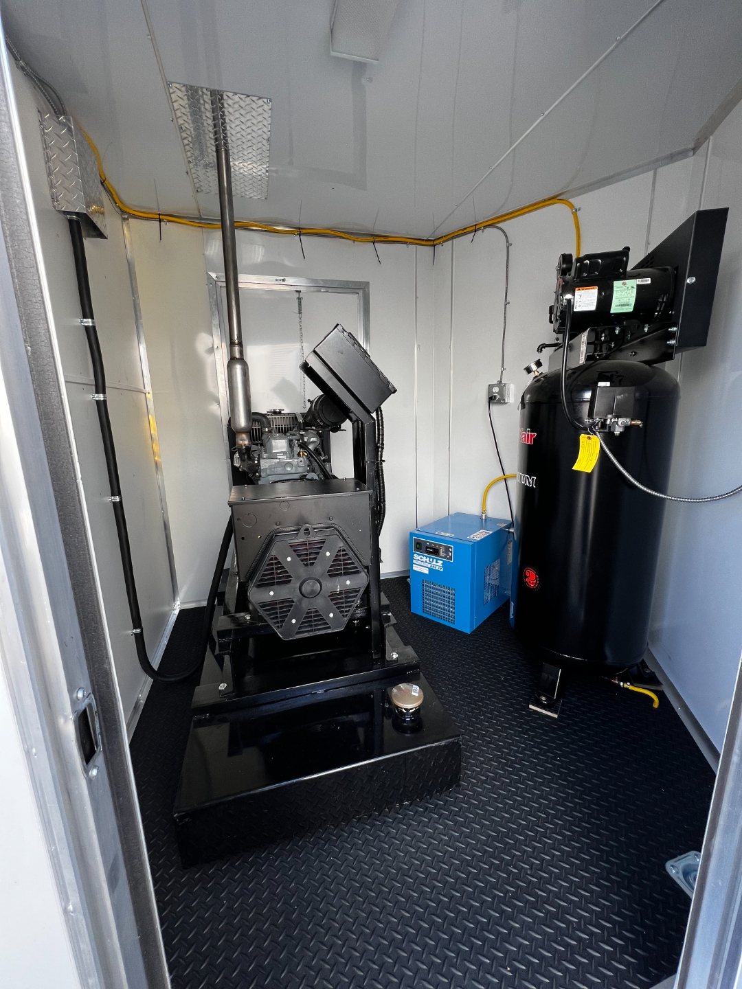 W&D Roofing professional spray foam equipment inside a commercial application trailer