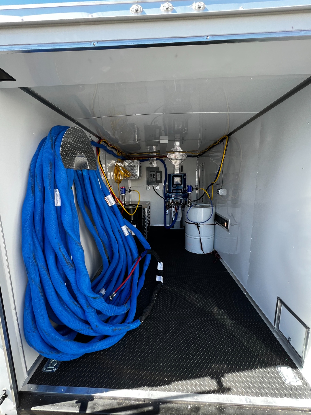 W&D Roofing spray foam equipment and hoses inside professional foam trailer