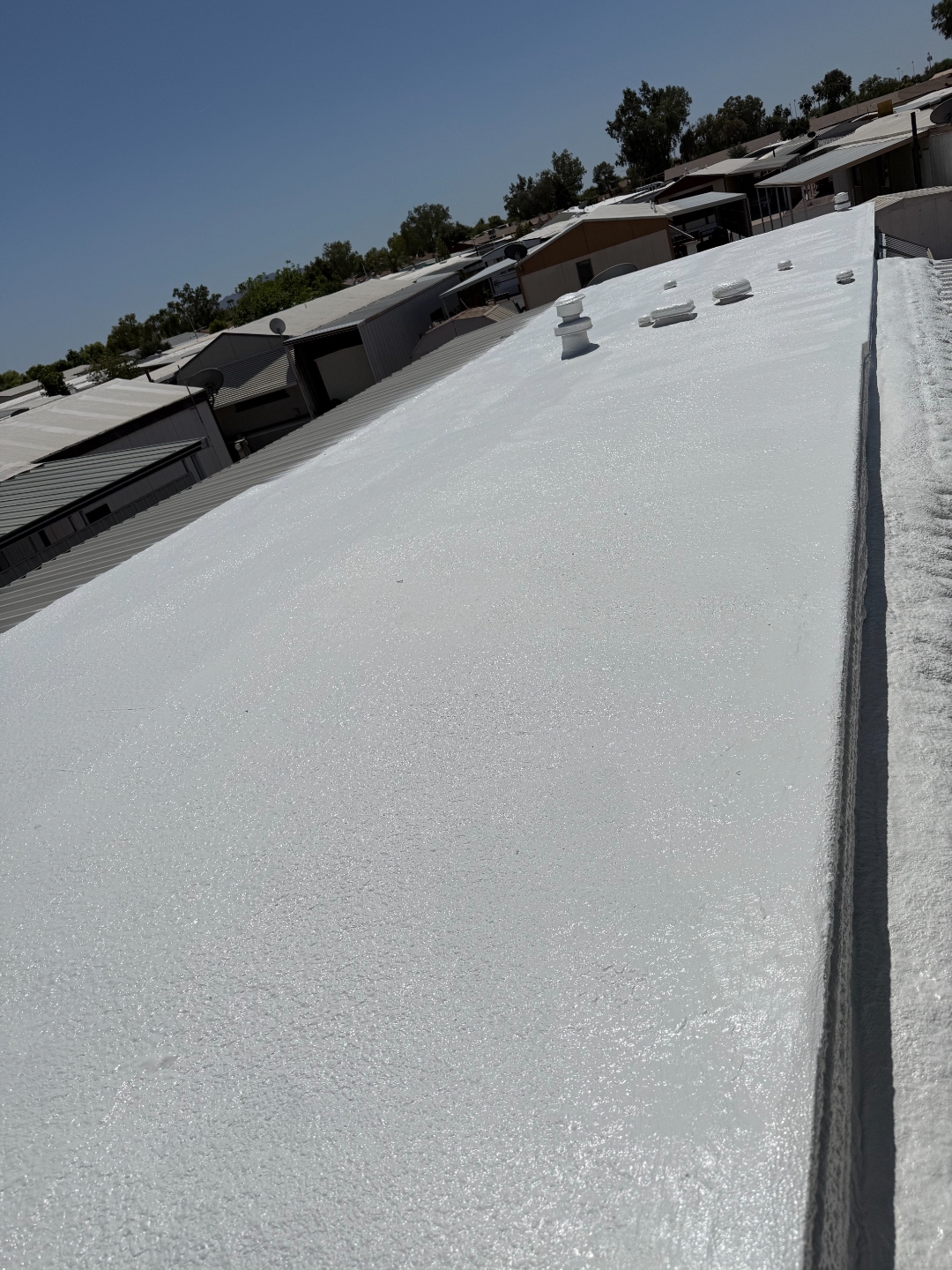 Finished mobile home foam roof repair with reflective coating by W&D Roofing