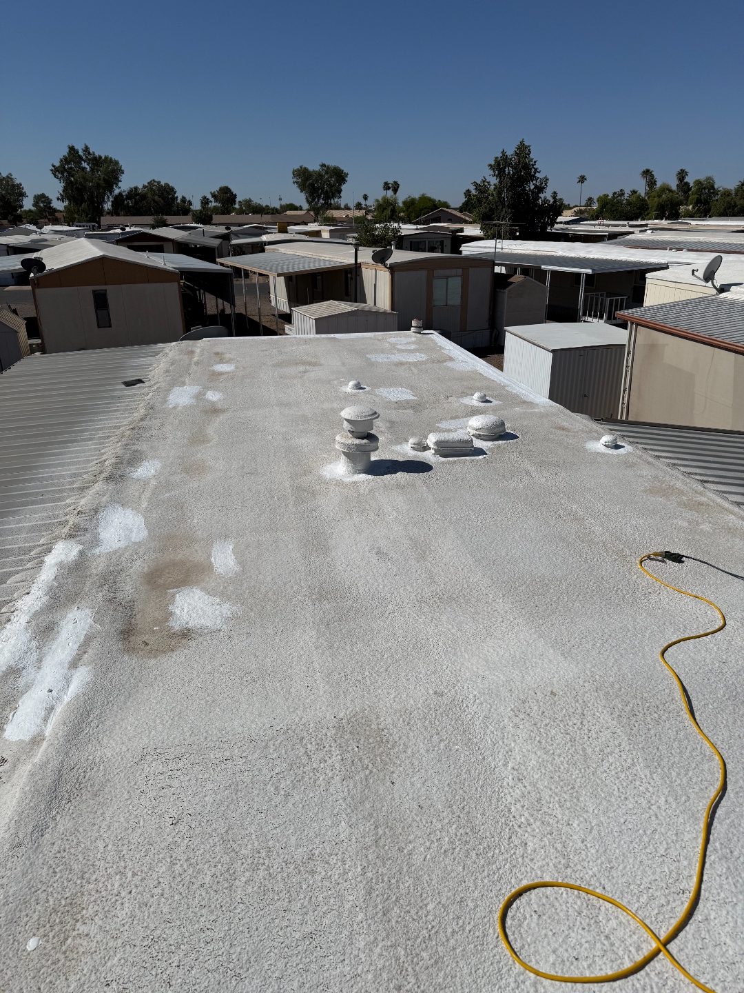 Mobile home foam roof repair preparation with patched roof details by W&D Roofing