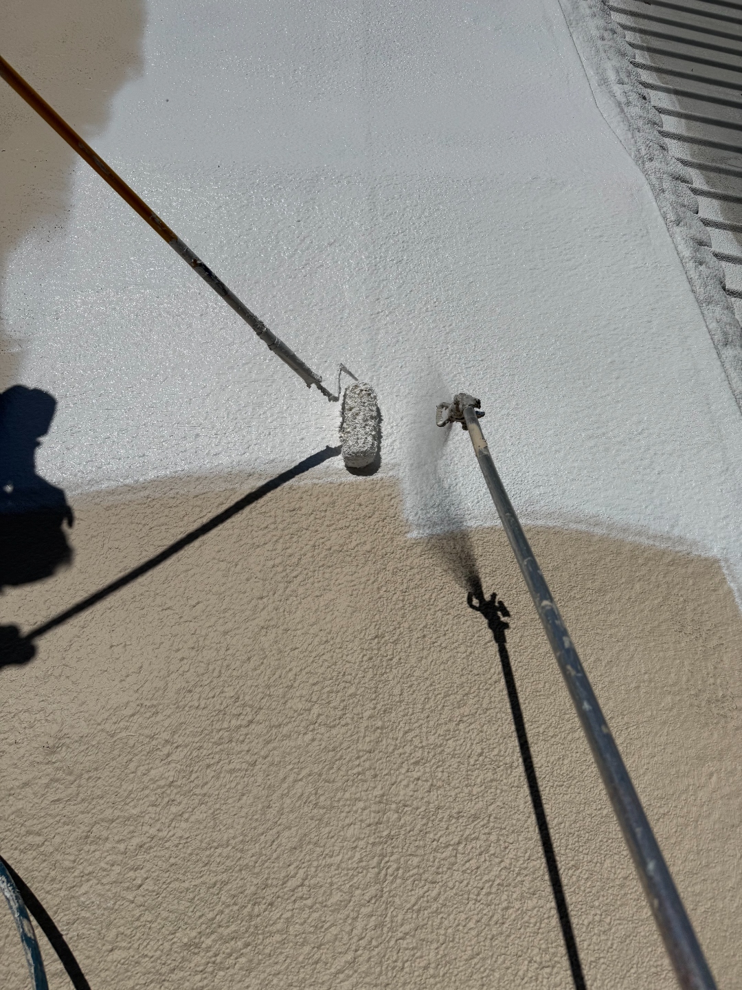 W&D Roofing applying reflective top coat over a mobile home foam roof repair