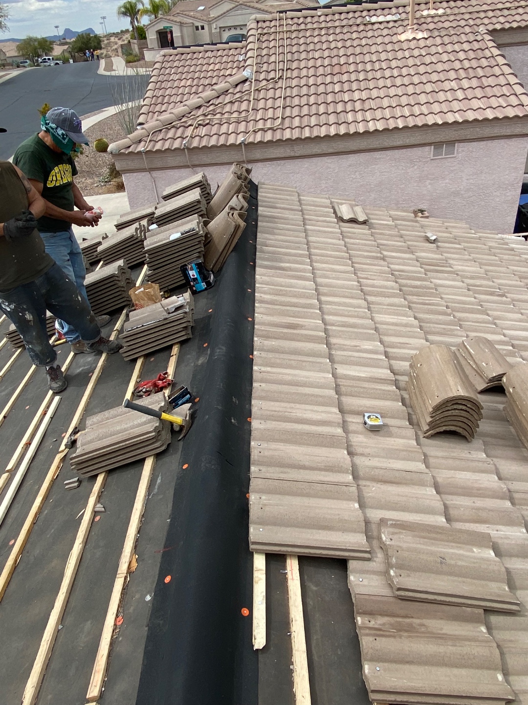 W&D Roofing concrete tile roof repair work with tile courses and underlayment visible