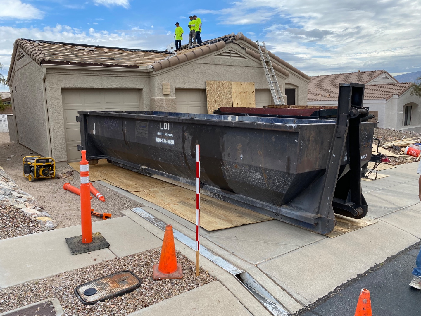 W&D Roofing tile roof replacement take-off with debris container and roof preparation