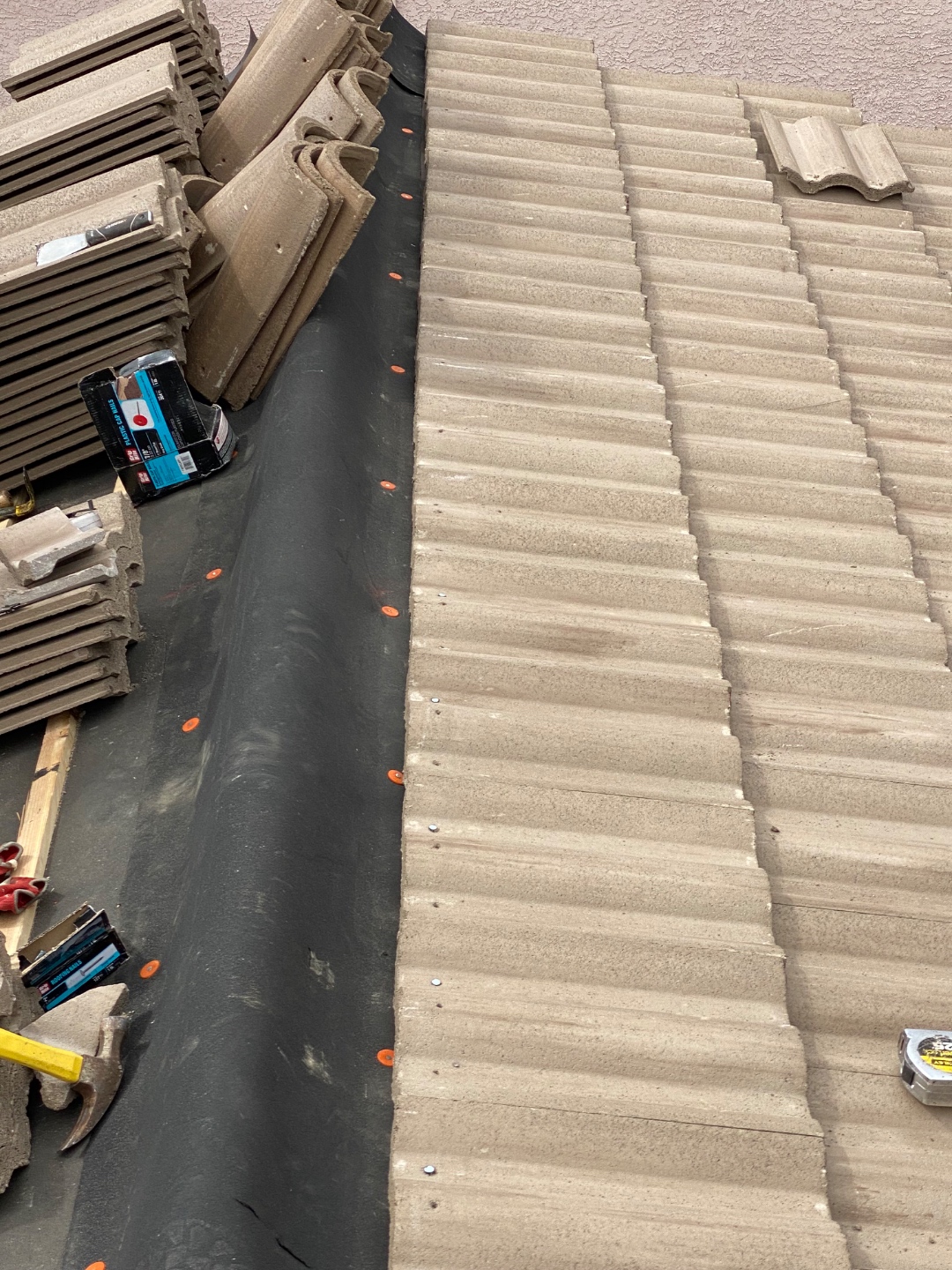 W&D Roofing tile roof underlayment replacement progress with tile courses being reset